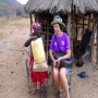 Asta Norrman sitting in front of hut